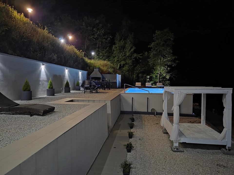 Terrace, pool, and cabana at night