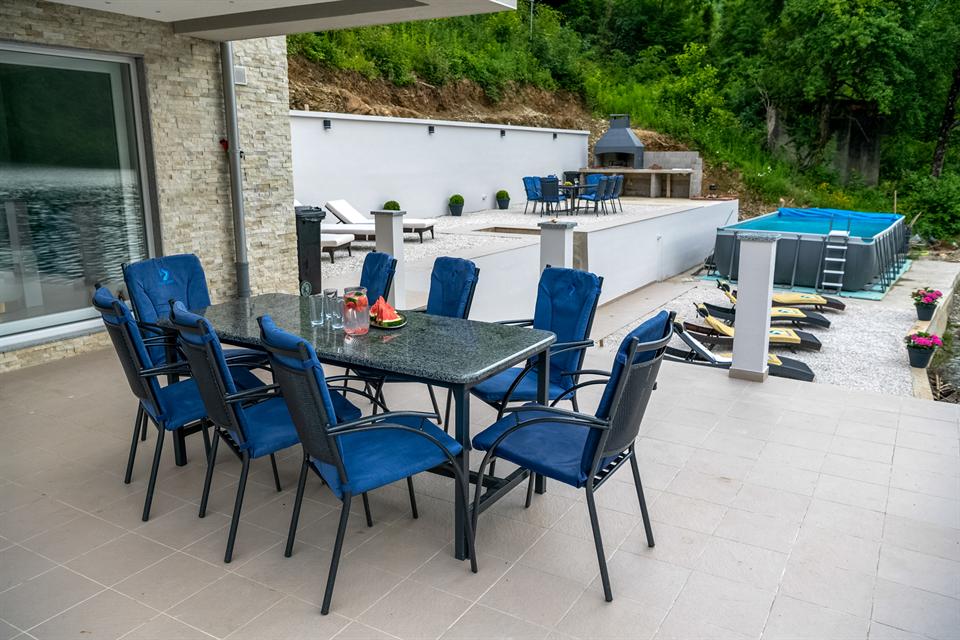 Outdoor dining table beside the pool terrace