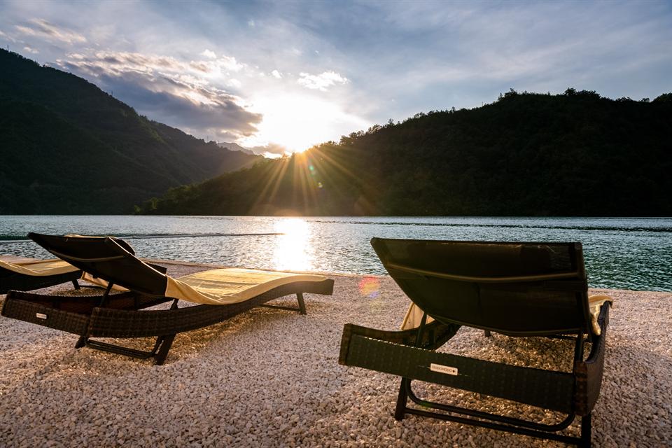 Sun loungers beside the water at sunset